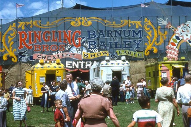 A digital reproduction of a photograph of the entrance of the Ringling & Barnum Bailey circus entrance with people walking in
