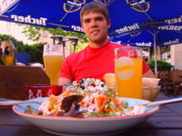 Adam Chambers is sitting down with a delicious looking plate of food in front of him.