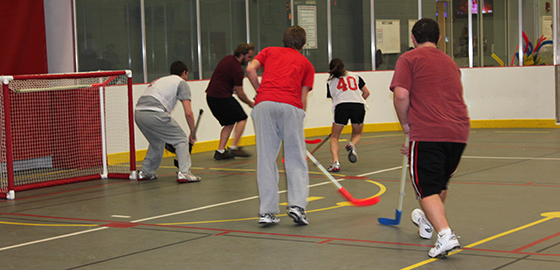 Students play floor hockey