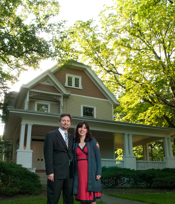Jessica '93 and Jason Chambers in front of their home, the former residence of Charles DeGarmo