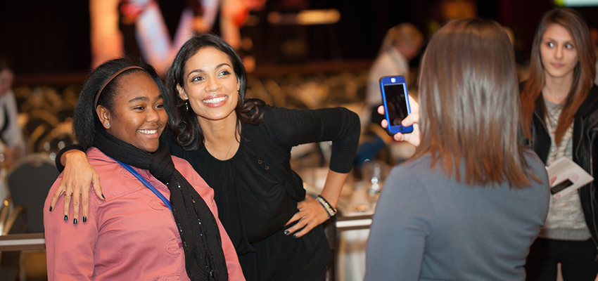 Rosario Dawson with a student