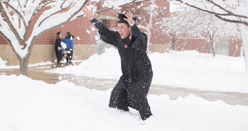 Graduate celebrates in the snow