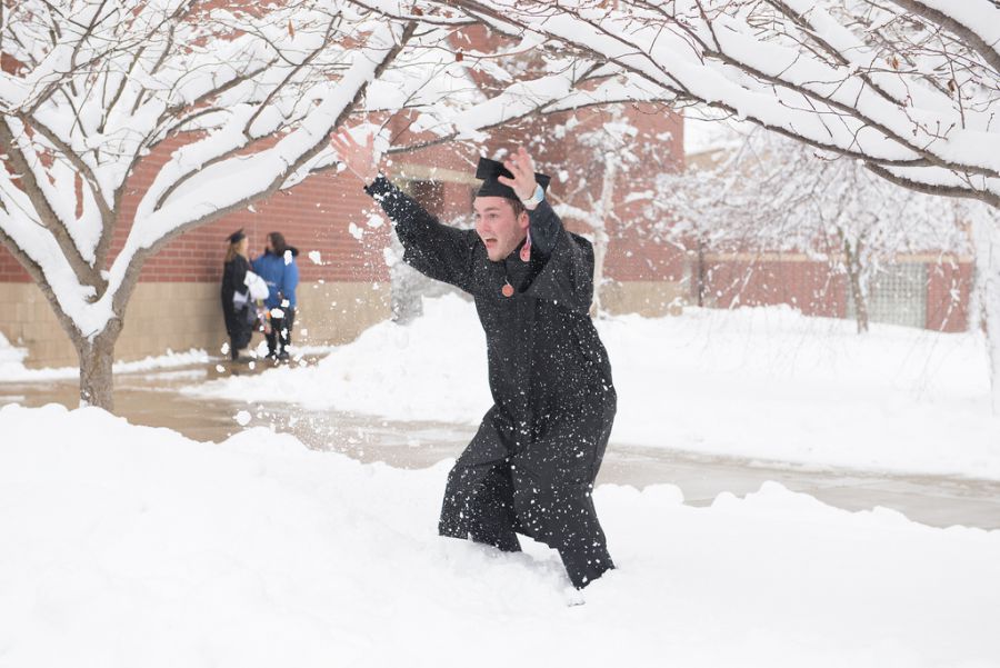 new graduate celebrates in snow