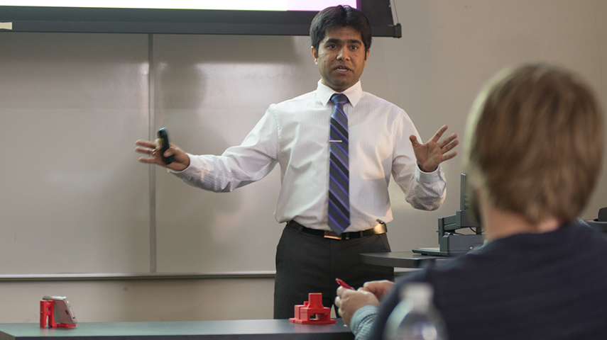 MBA student Aniruddha Godbole explains the process of creating and determining the market for his team’s smartphone stand.