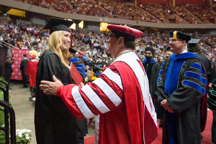 Larry Dietz congratulates a graduate