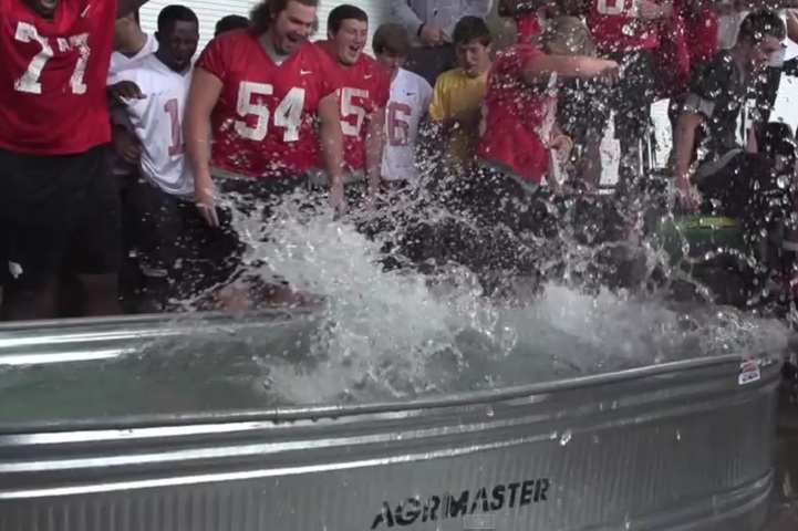 Football players dive into ice bucket