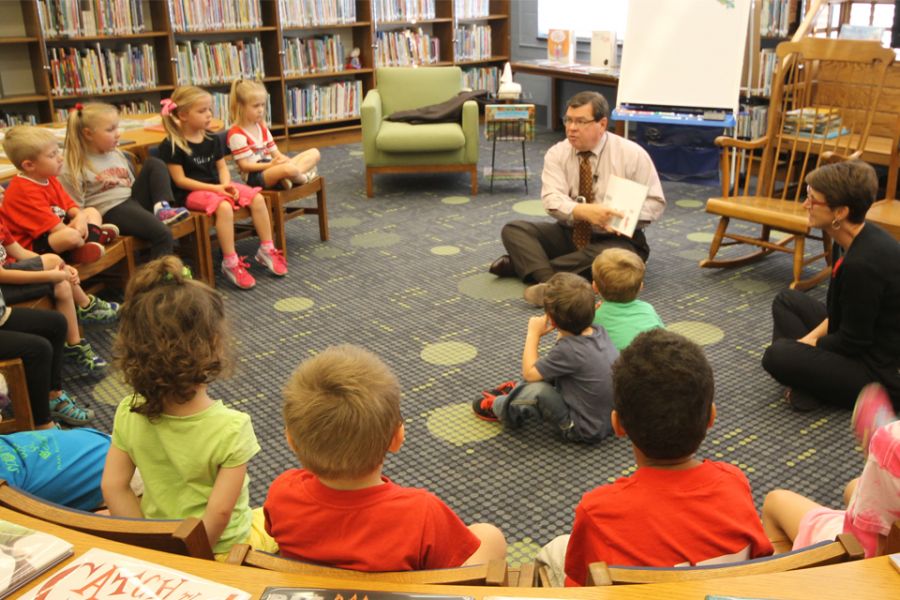 Illinois State University President Larry Dietz reads to Pre-K students in Thomas Metcalf' School's Zimmerman Library.