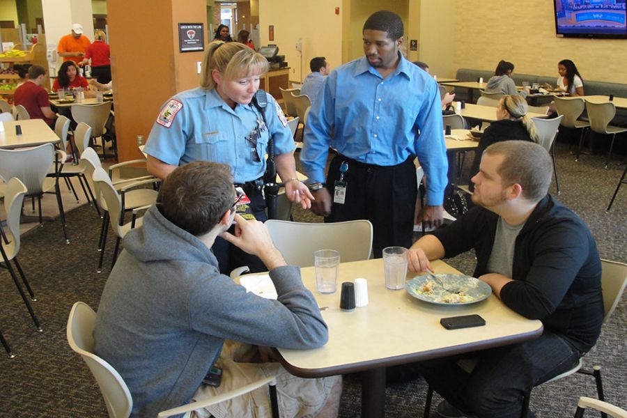 Police officers speak with students.