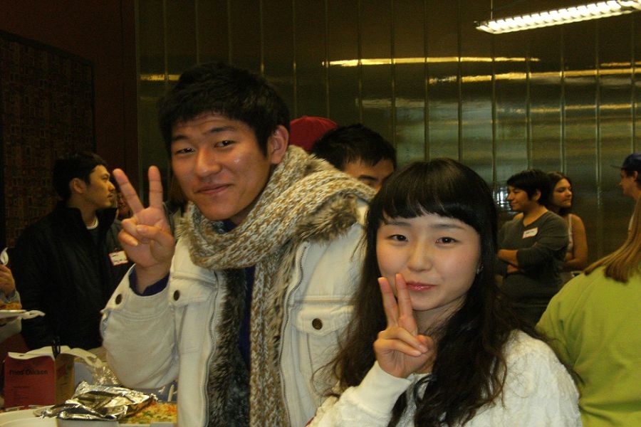 Men and woman showing peace sign