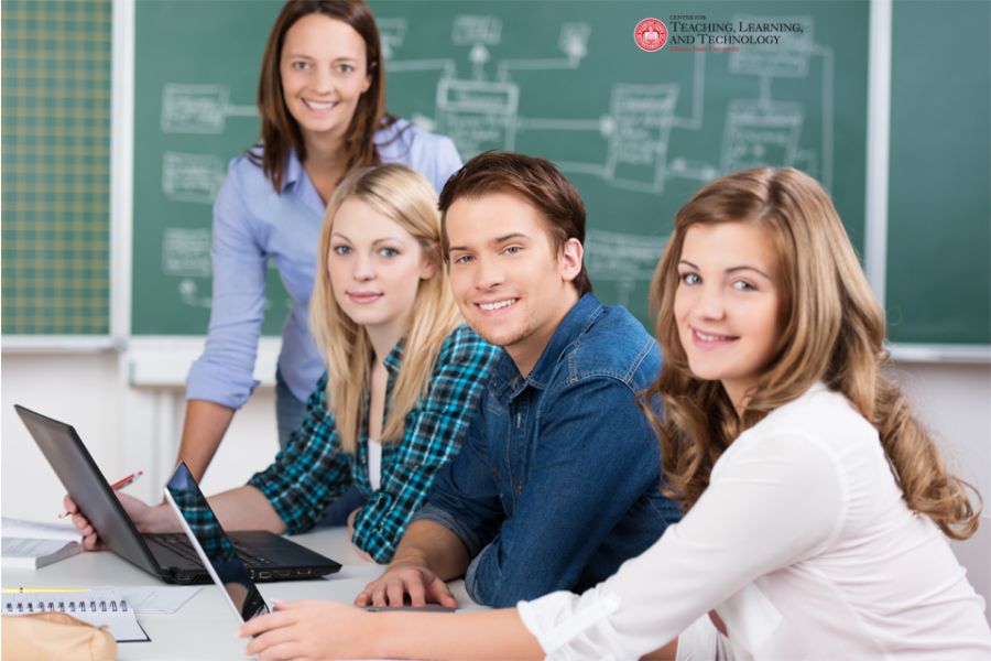 students and professor in classroom with technology