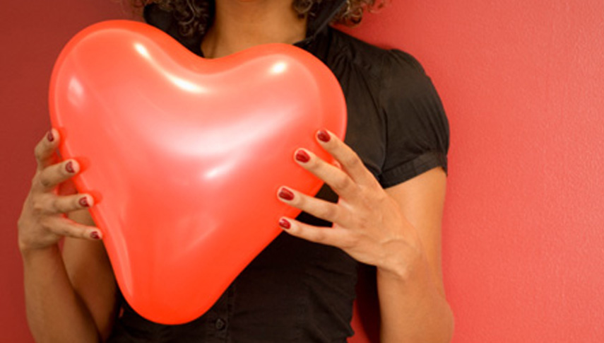 Woman holding a heart-shaped balloon