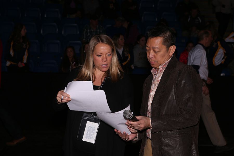 Two people conferring over a paper