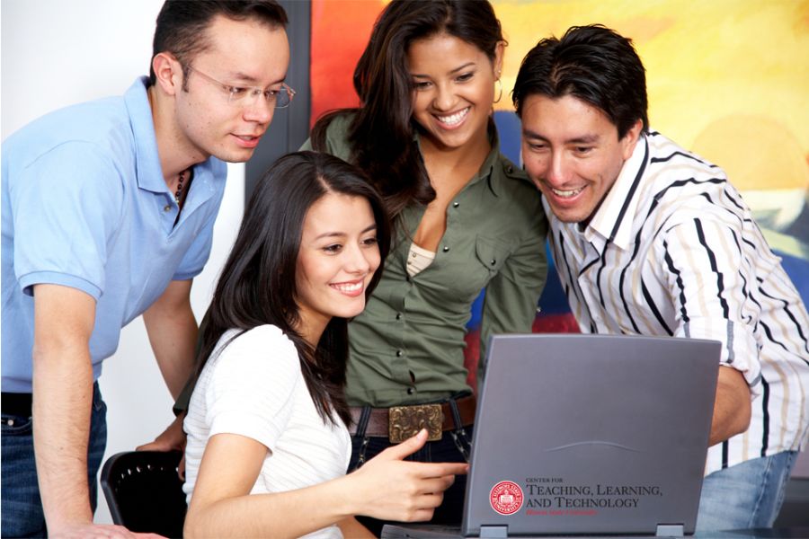group of diverse students looking at computer