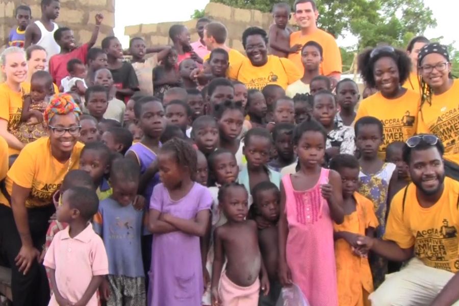 students pose with kids in Ghana