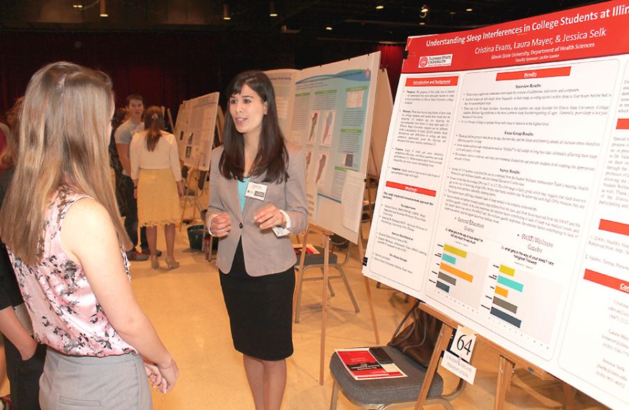 Female student presenting at research symposium