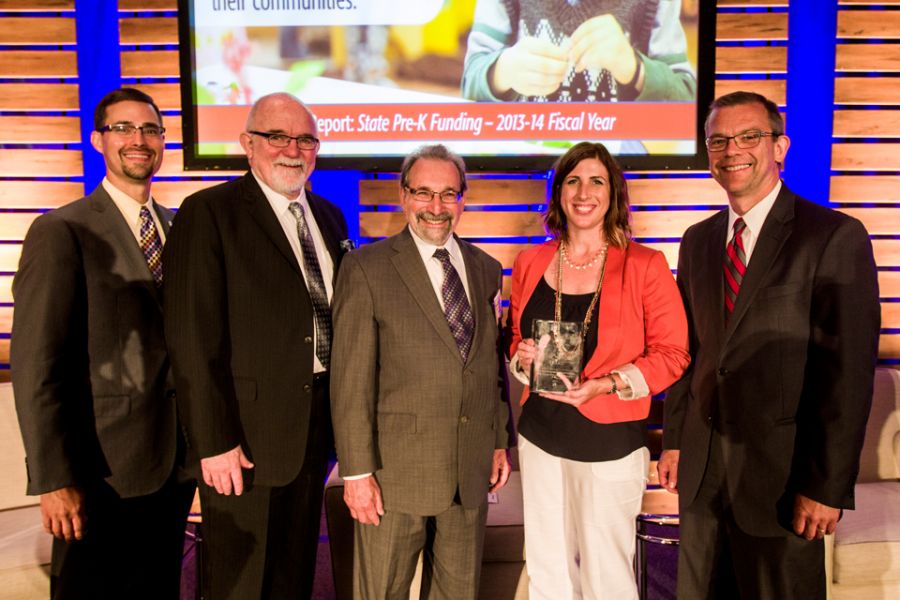 In July 2014, Erika Hunt and Lisa Hood went to Washington, D.C., with former State Superintendent Chris Koch and IBHE Director James Applegate and former Director Harry Berman to accept the 2014 Frank Newman Award for State Innovation at the Education Commission of the States conference on behalf of the state of Illinois for the work around the new P–12 Principal Endorsement. (left to right) Harry Berman, former executive director of the Illinois Board of Higher Education; Brian Sandoval, Utah governor and chair of the Education Commission of the States; Erika Hunt; James Applegate, executive director of the Illinois Board of Higher Education, and Chris Koch, former state superintendent of the Illinois State Board of Education.