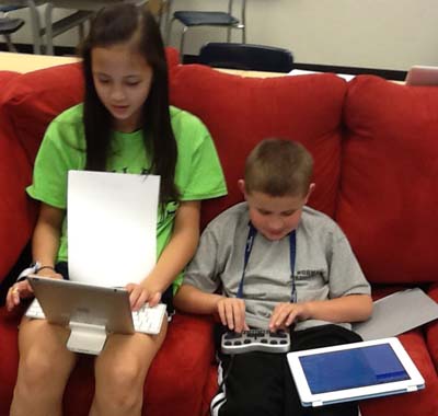 Children using technology to learn.