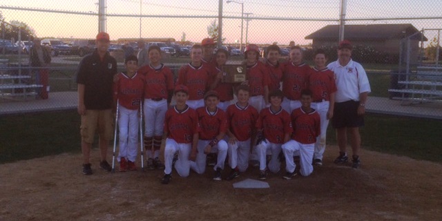 Baseball players pose for a picture after their win at regionals.