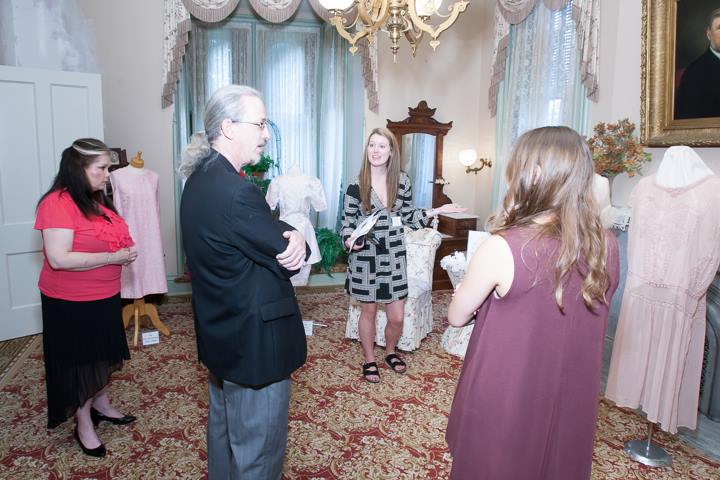 Dr. Bill and Phoebe Anderson talk with Illinois State apparel, merchandising, and design student docents at the David Davis Mansion.