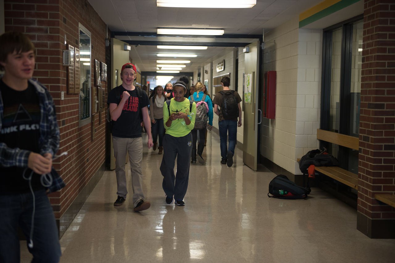 Two students in school hallway
