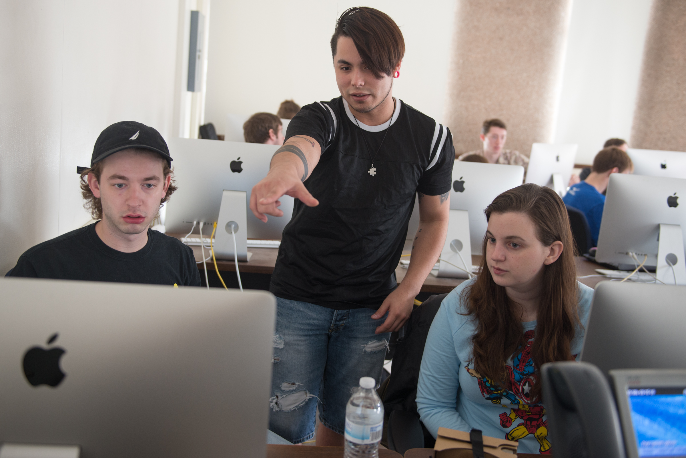 3 students look at a computer