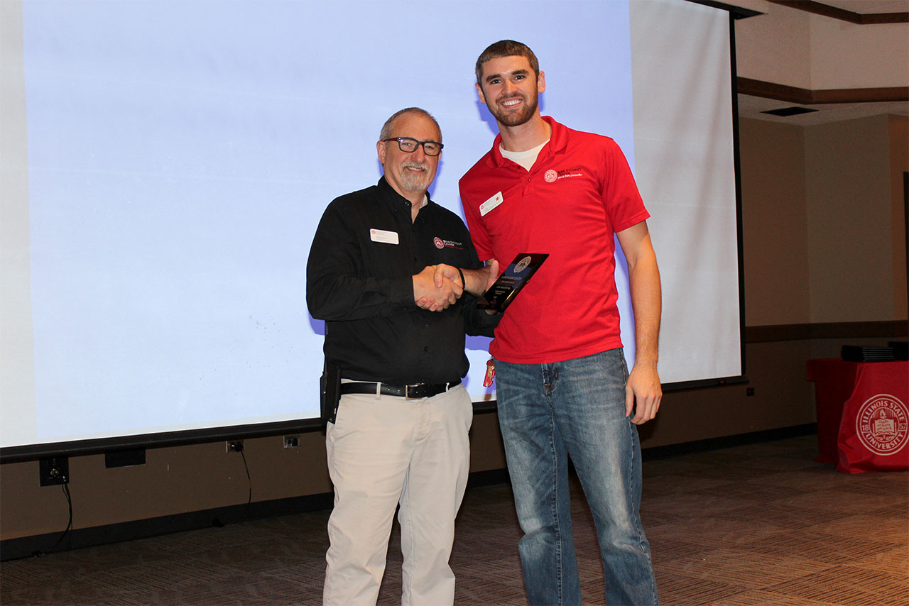 Junior Cole Hasselbring receives the Student Employee of the Year award from Assistant Director of the Bone Student Center Patrick O'Connell.
