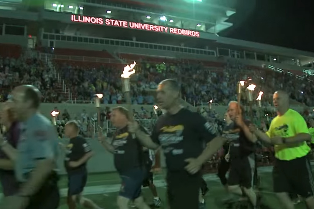 Runners with torches arrive at Hancock