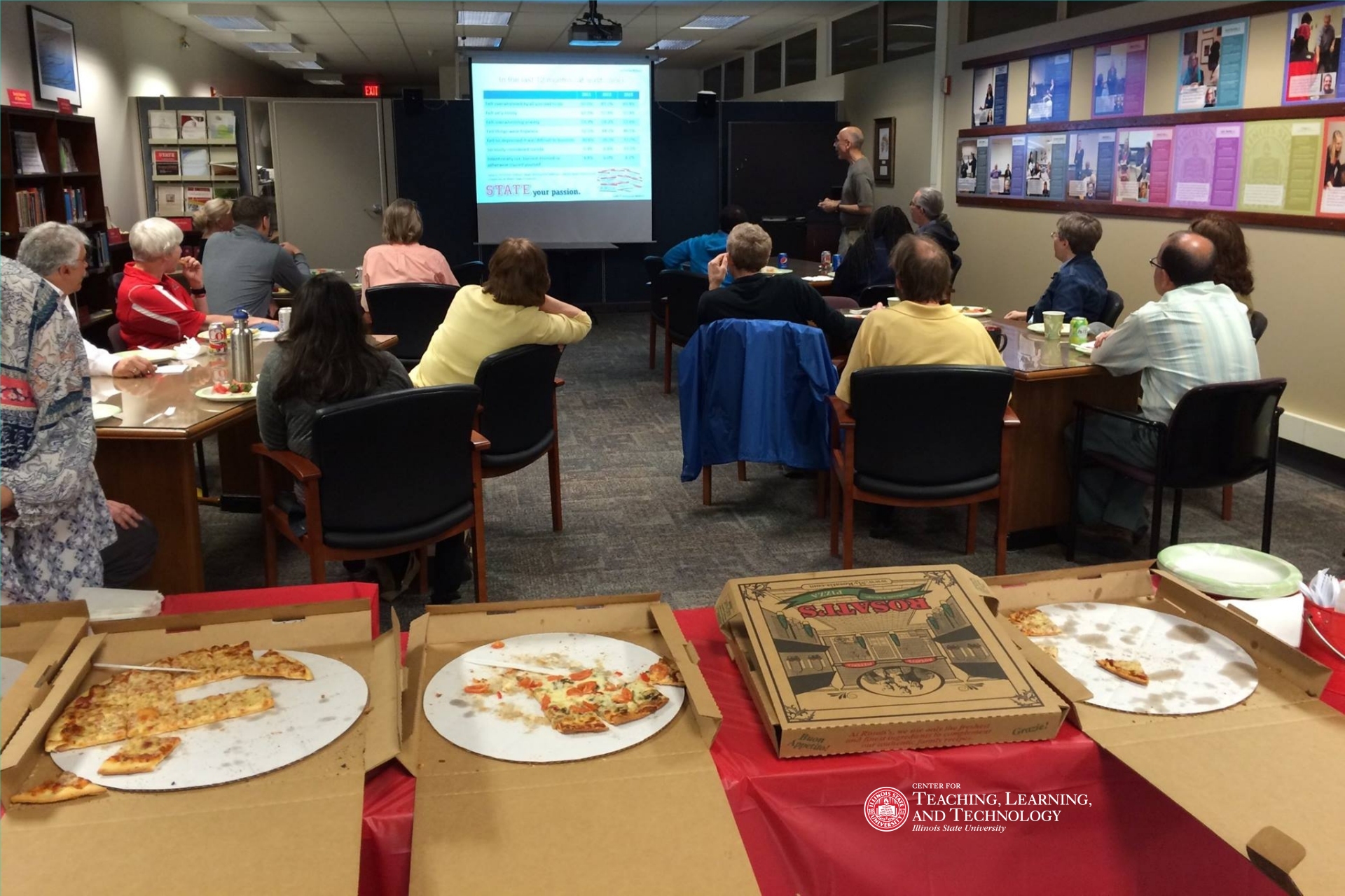 Faculty and staff in a workshop with pizza!