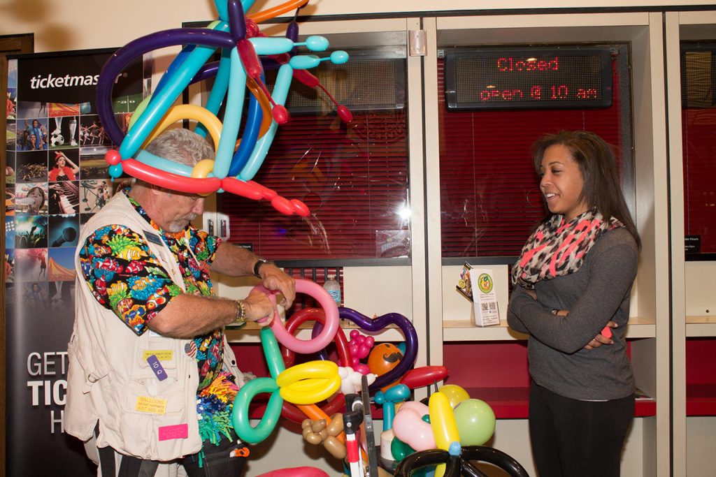 Student gets a balloon animal during the UPB Homecoming Carnival.