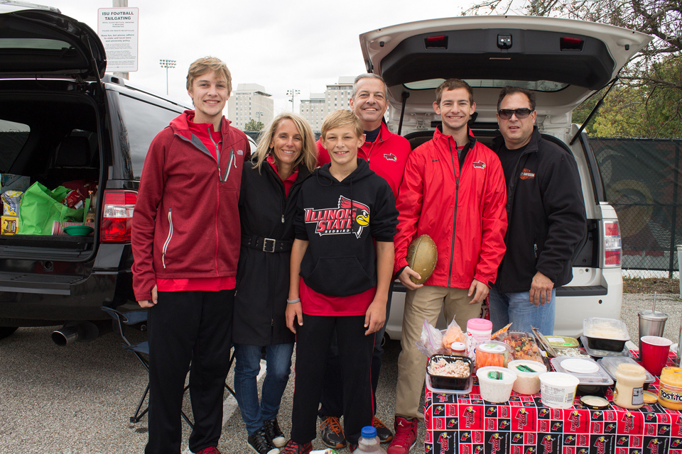 family smiling at tailgate