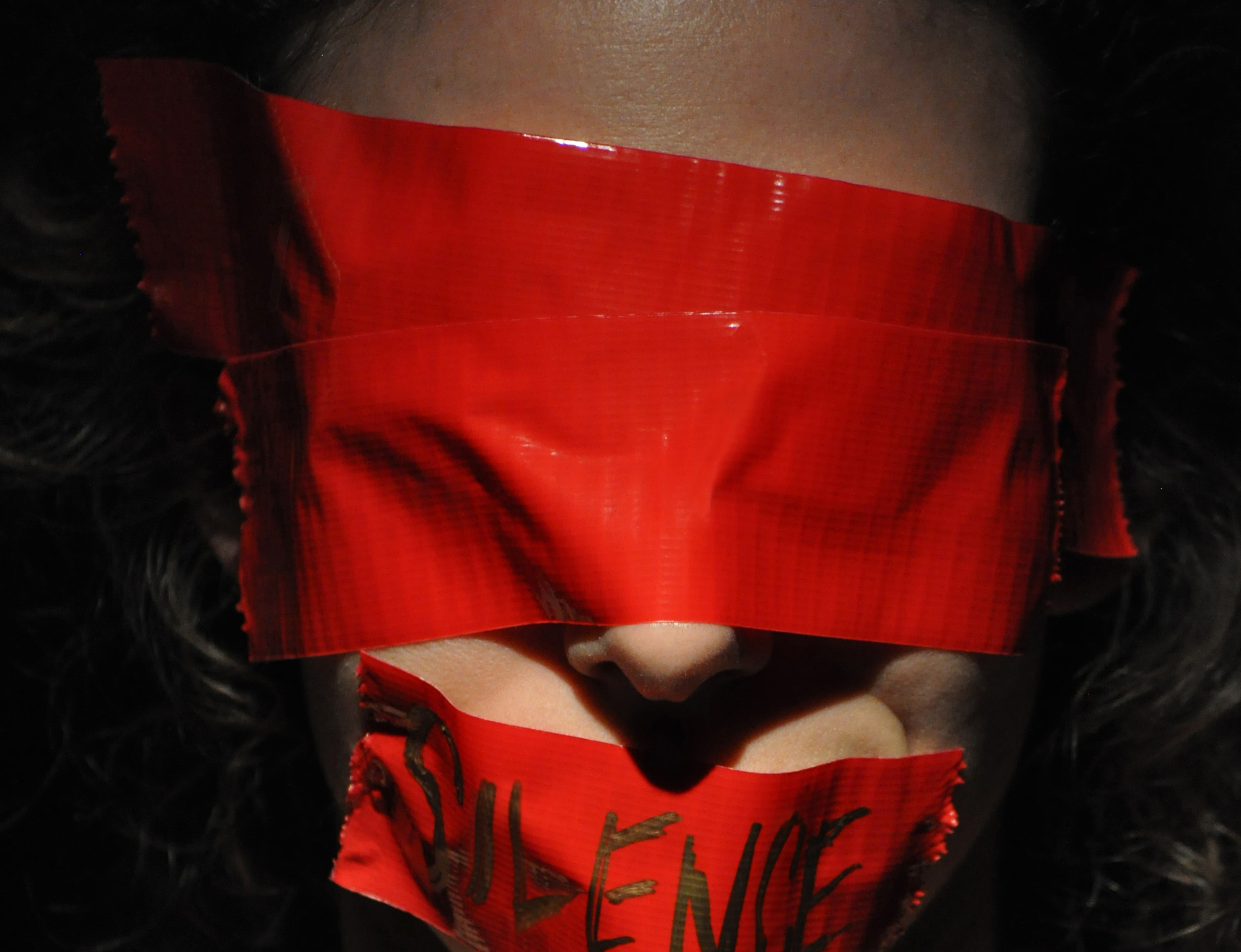 image of a woman silence and blindfolded.