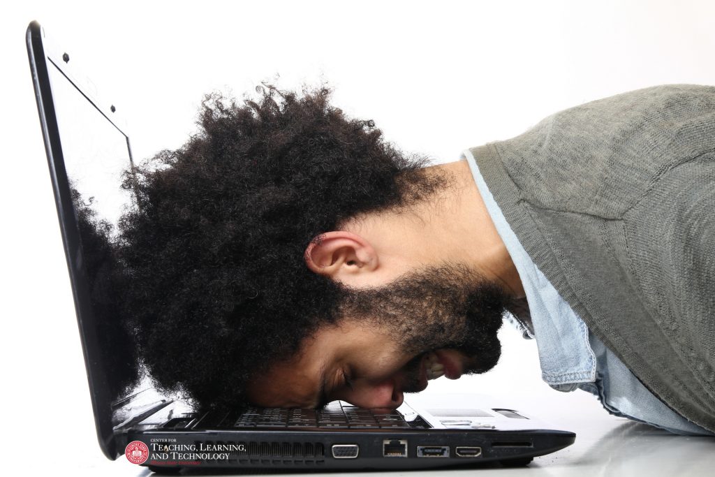 Man hitting head on laptop keyboard