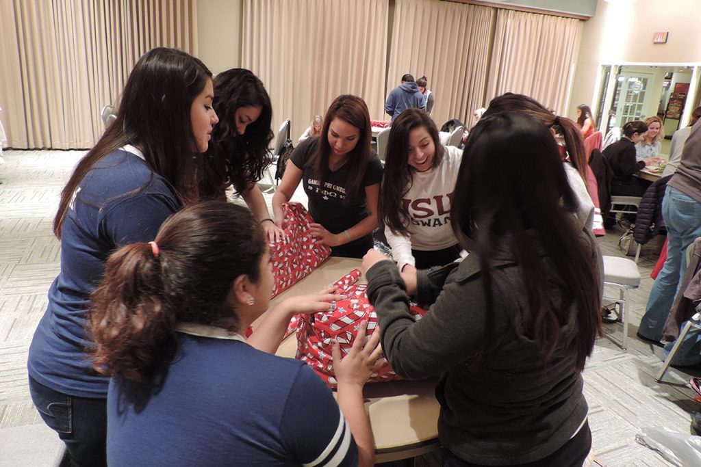 Students wrap gifts for Holiday Helper