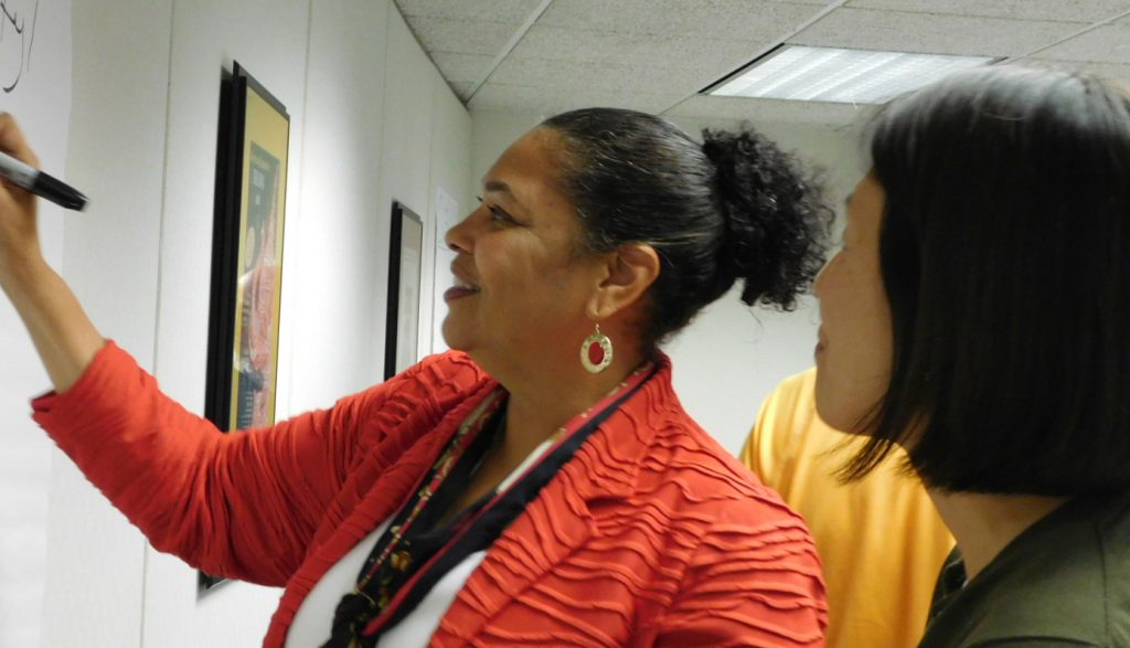 image of Climate Task Force Co-Chair Doris Houston works with another member of the group.