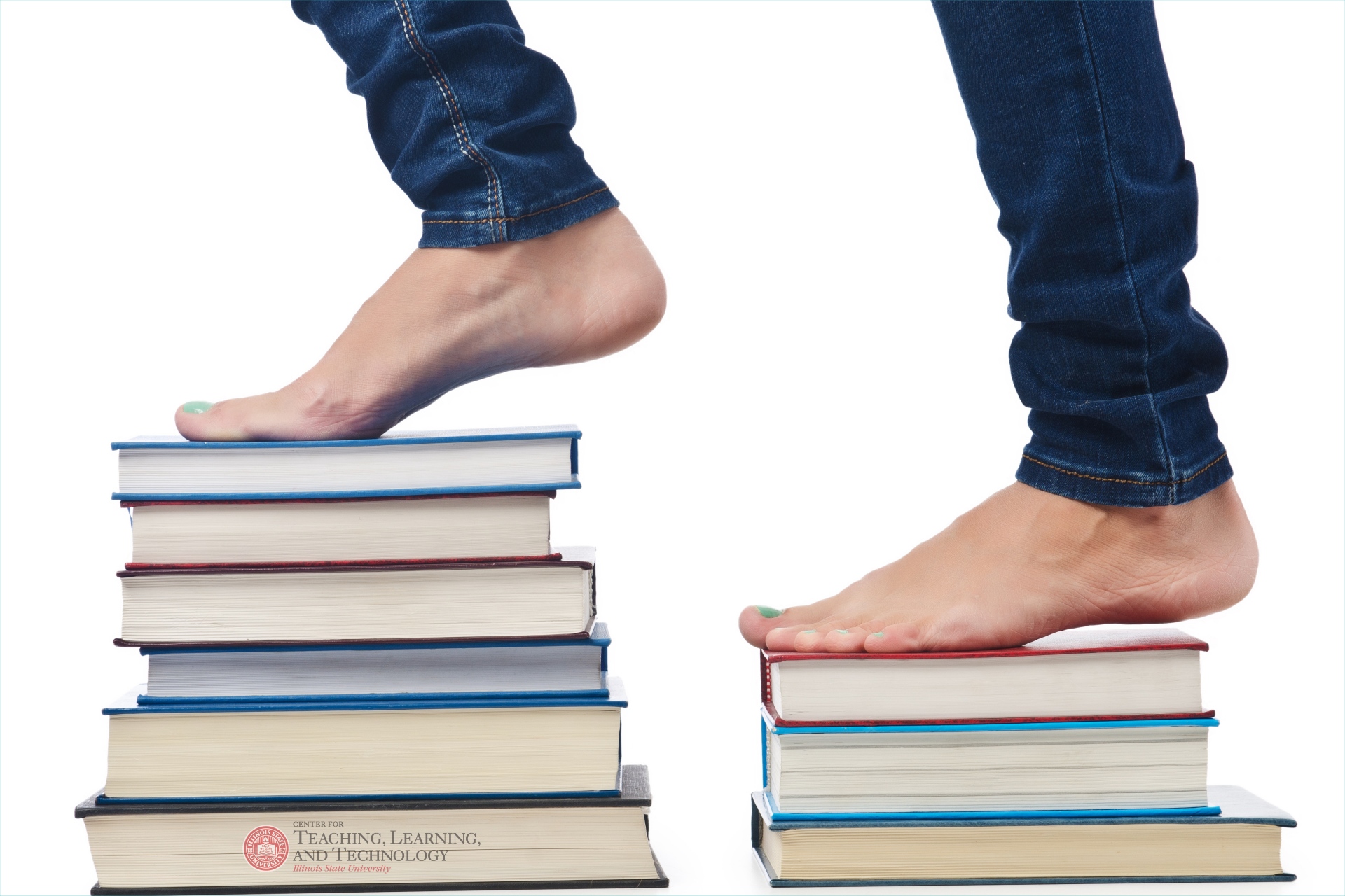 Bare feet on a pile of books