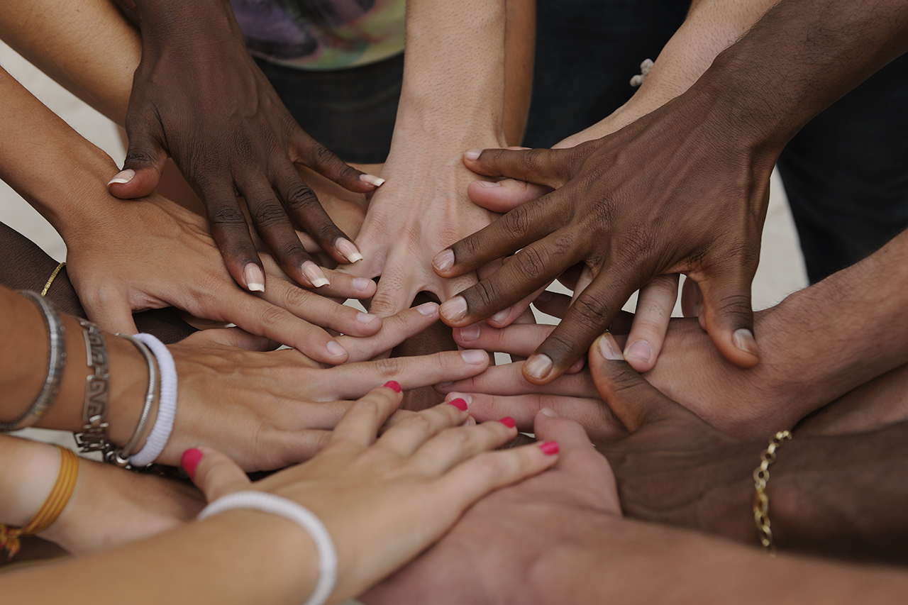 Image of many hands together