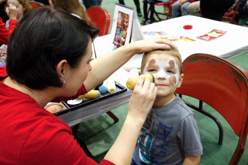 image of little boy getting face painted.