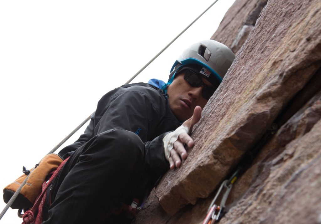 Photo of Steve Baskis rock climbing.