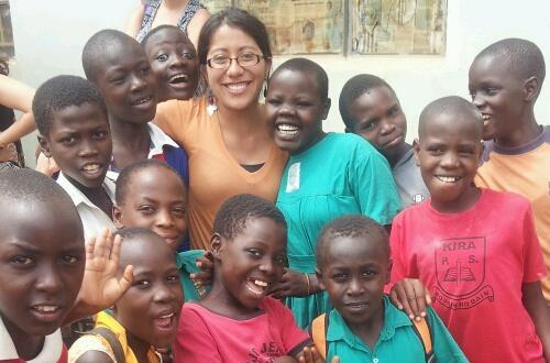 Campus recruiter Vanessa Soto as a Peace Corps volunteer in Uganda surrounded by children