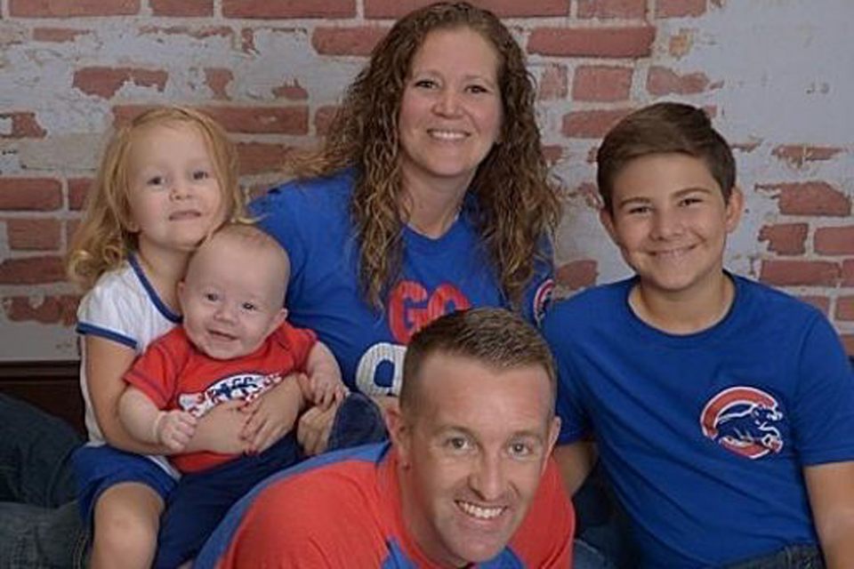 Ben Piper poses with his family in Cubs gear