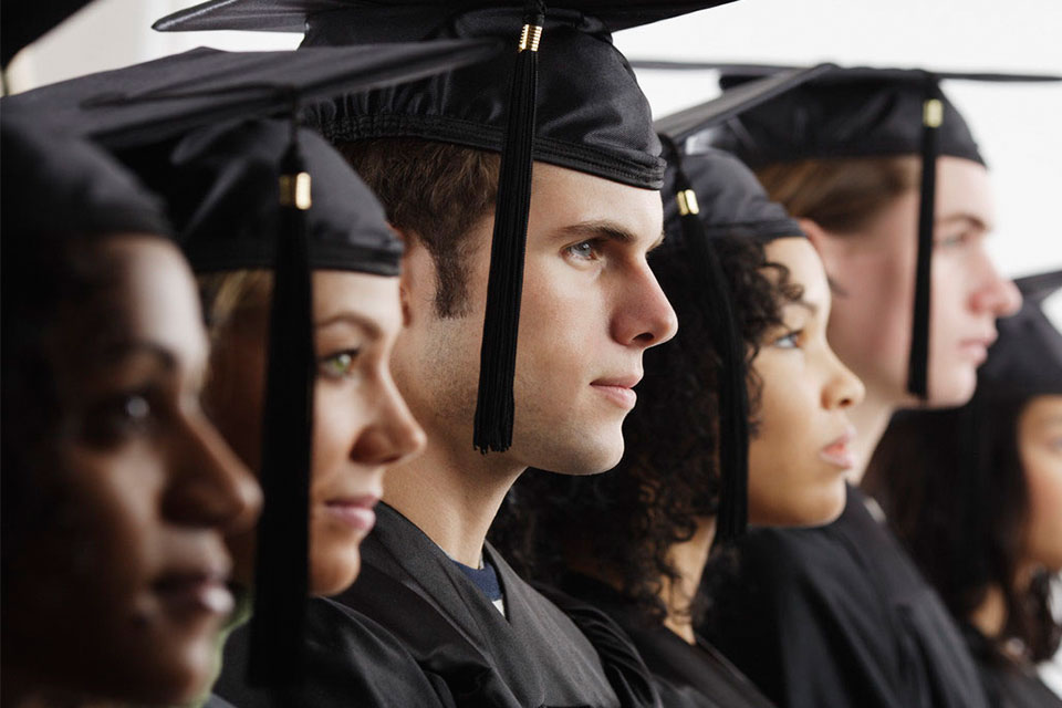 Students lined up wearing mortarboards