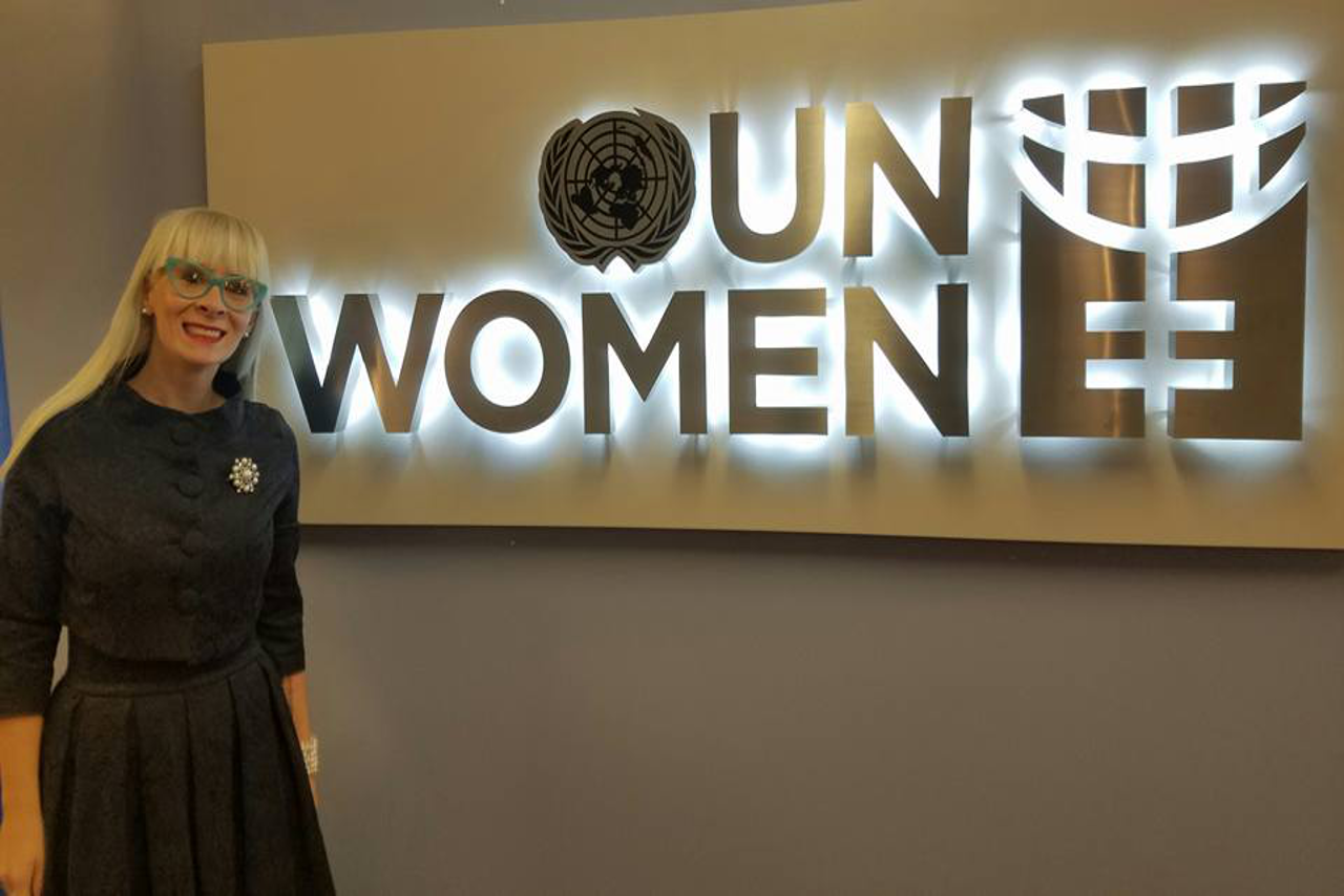 Criminal Justice Sciences Professor Shelly Clevenger in front of UN Women sign