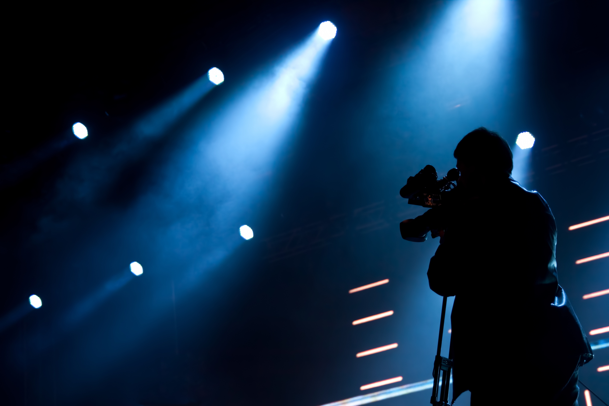 image of Cameraman silhouette on a concert stage