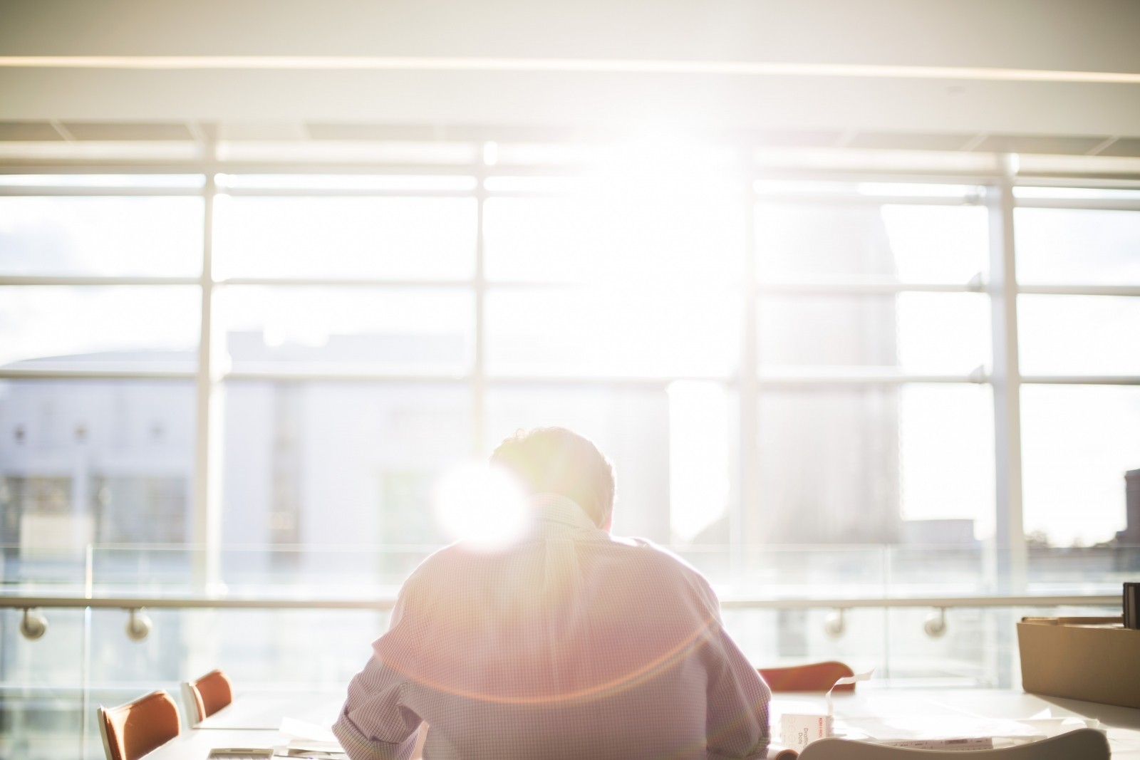 Person sitting at desk bathed in sunlight