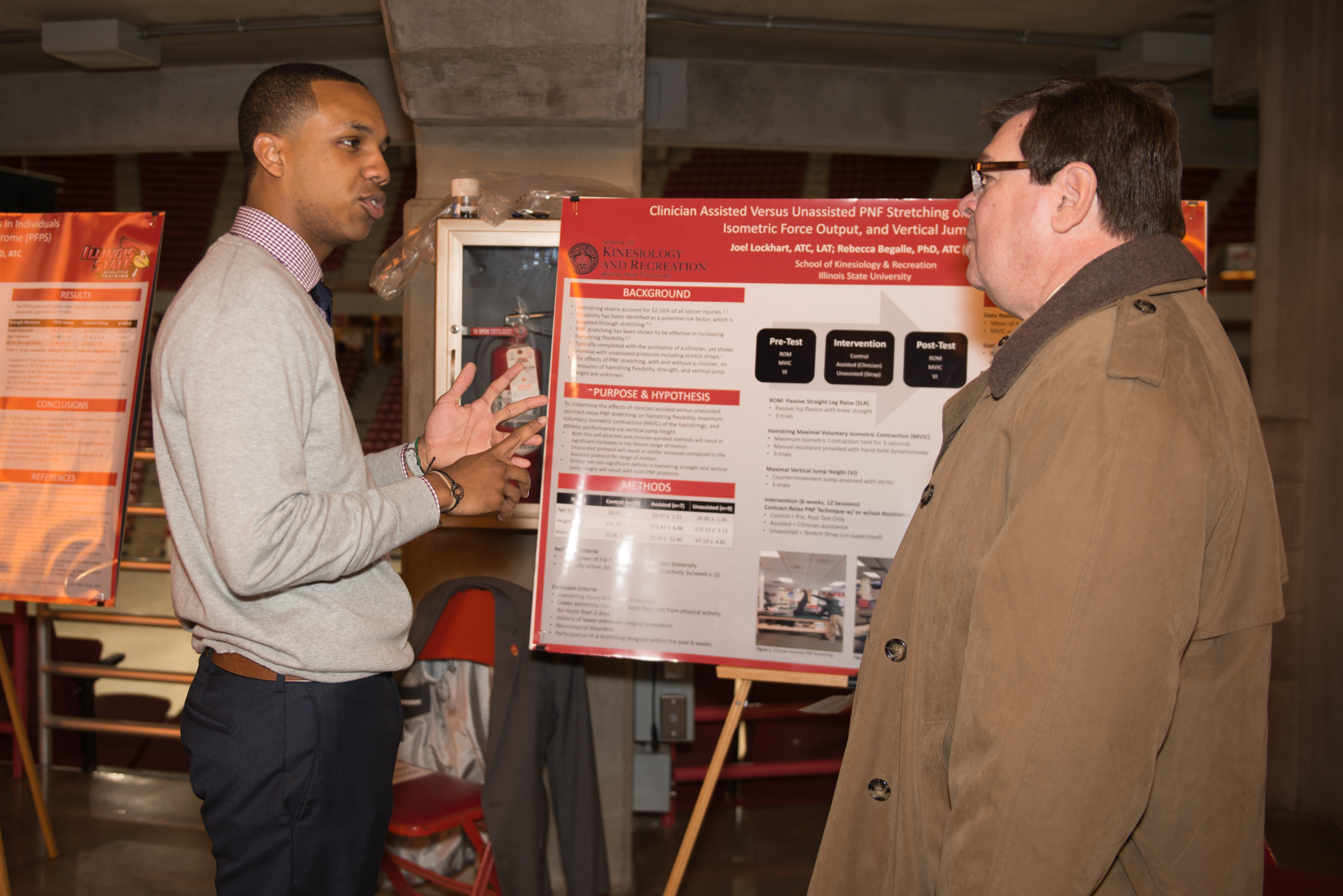 Graduate student Joel Lockhart talks to President Larry Dietz about the former's athletic training research.