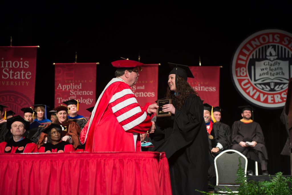 Emily Vigneri accepts the Civil Service Distinguished Service Award from President Larry Dietz at this year's Founders Day Convocation.