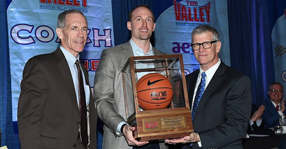 Dan Muller accepting the the trophy for MVC Coach of the Year with MVC officials