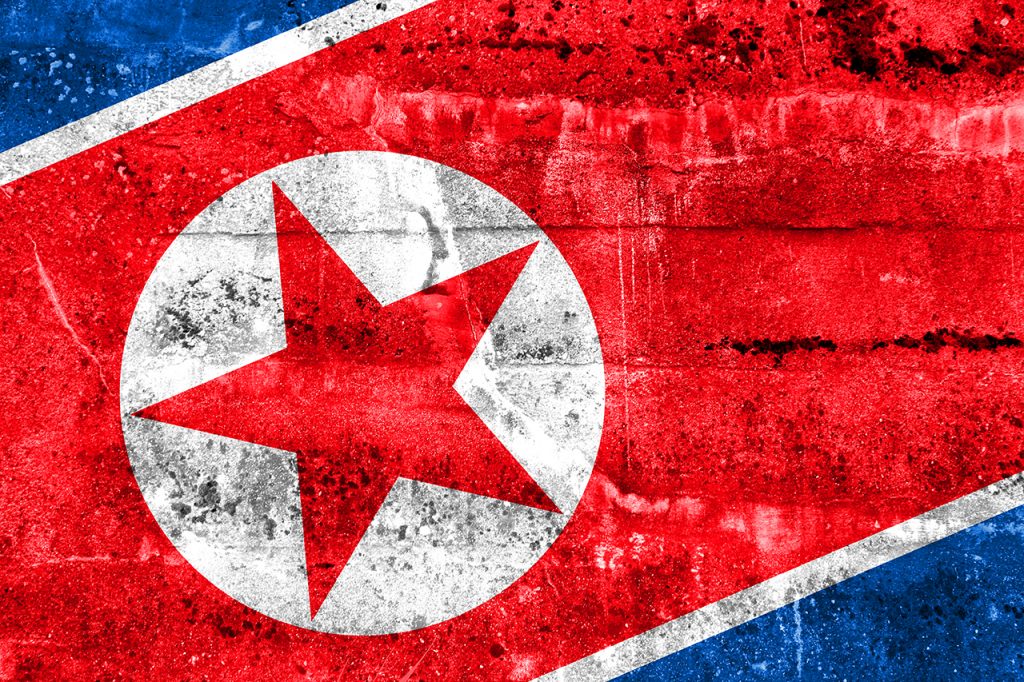 image of North Korean flag painted on a wall.