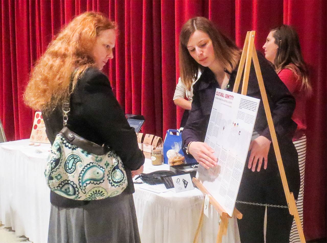 Image of a student displaying research at the University Research Symposium.