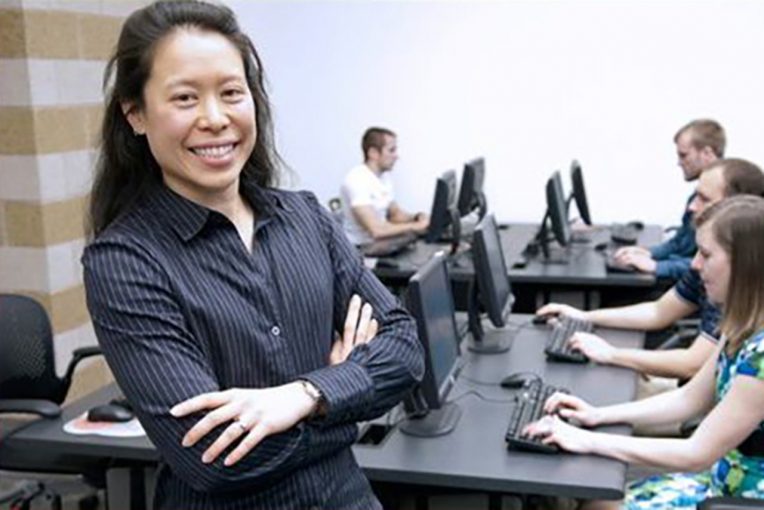 Accounting Professor Rosie Hauck in a classroom with students in front of computers